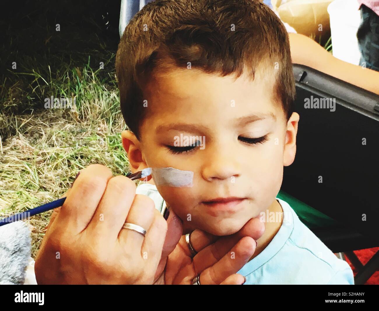 Boy having his face painted Stock Photo Alamy