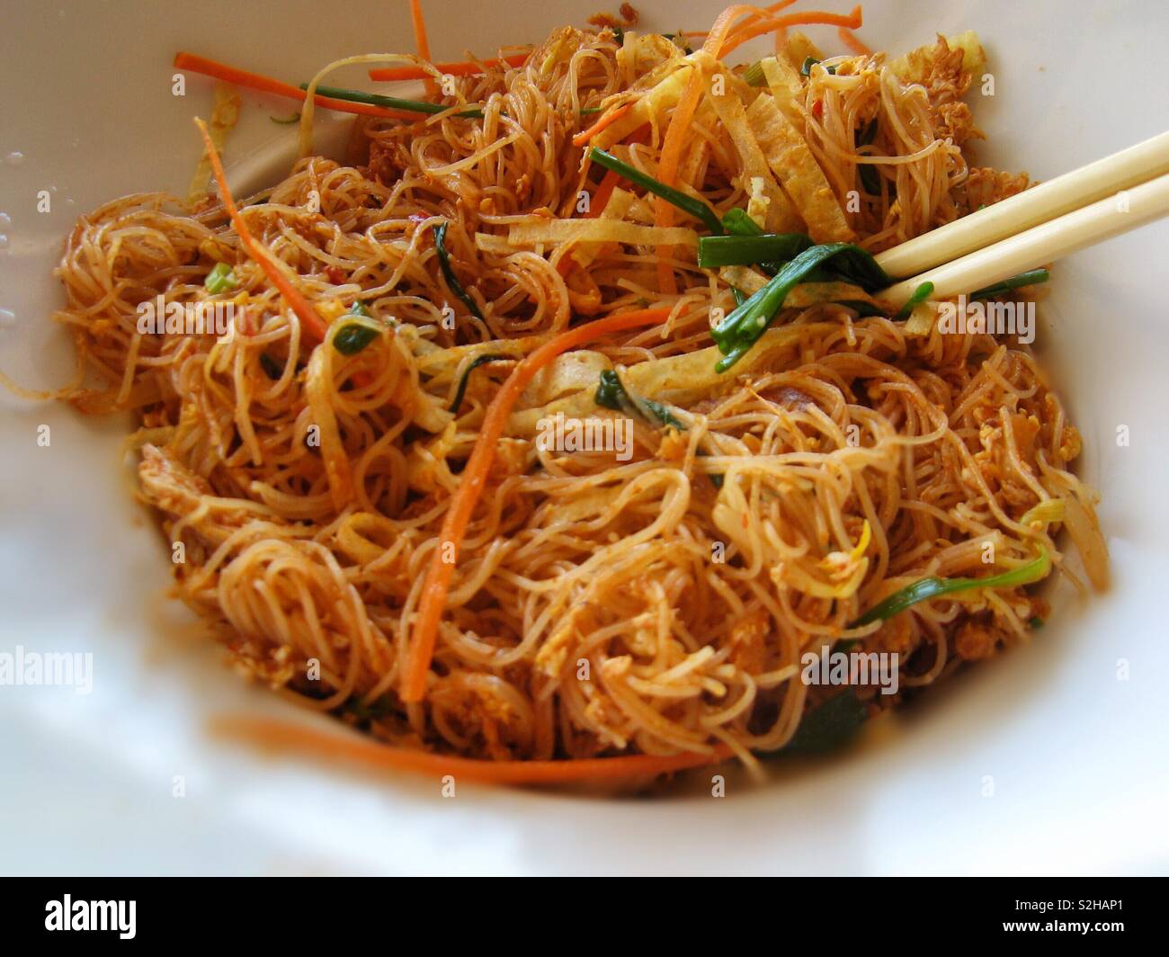 Noodles in a bowl with chop sticks.  Malaysian Chinese Thai Indonesian cuisine - Smartphone Captured Stock Image