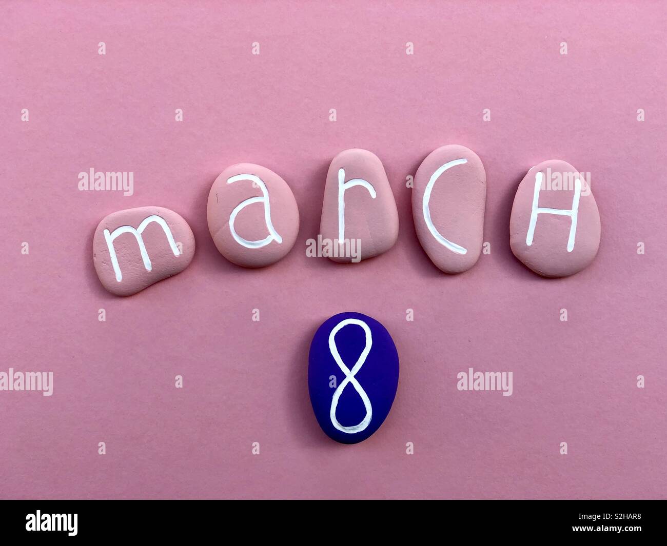 8 March, women’s day celabrated with pink colored stones over pink background Stock Photo