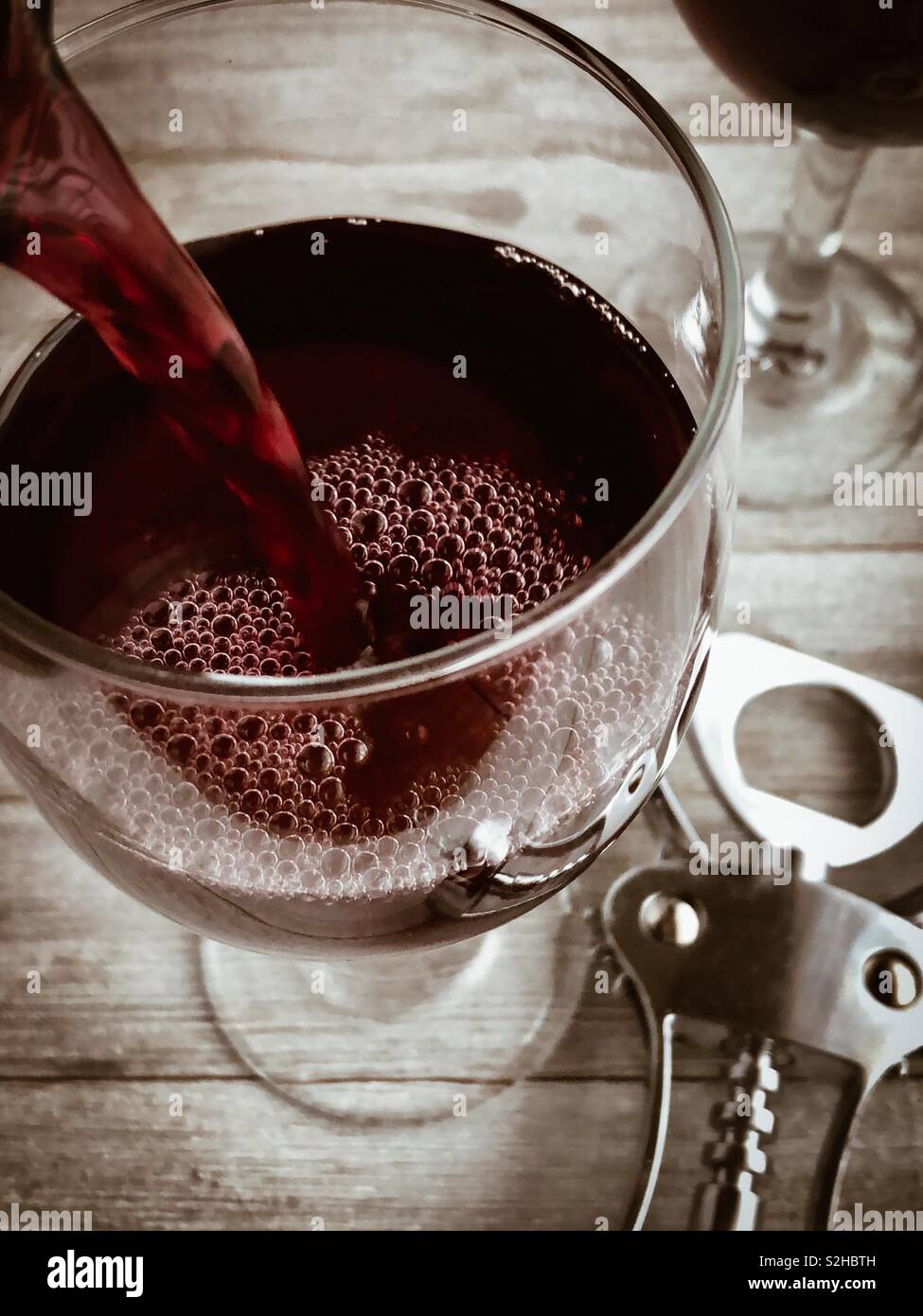 Red wine being poured into a glass Stock Photo