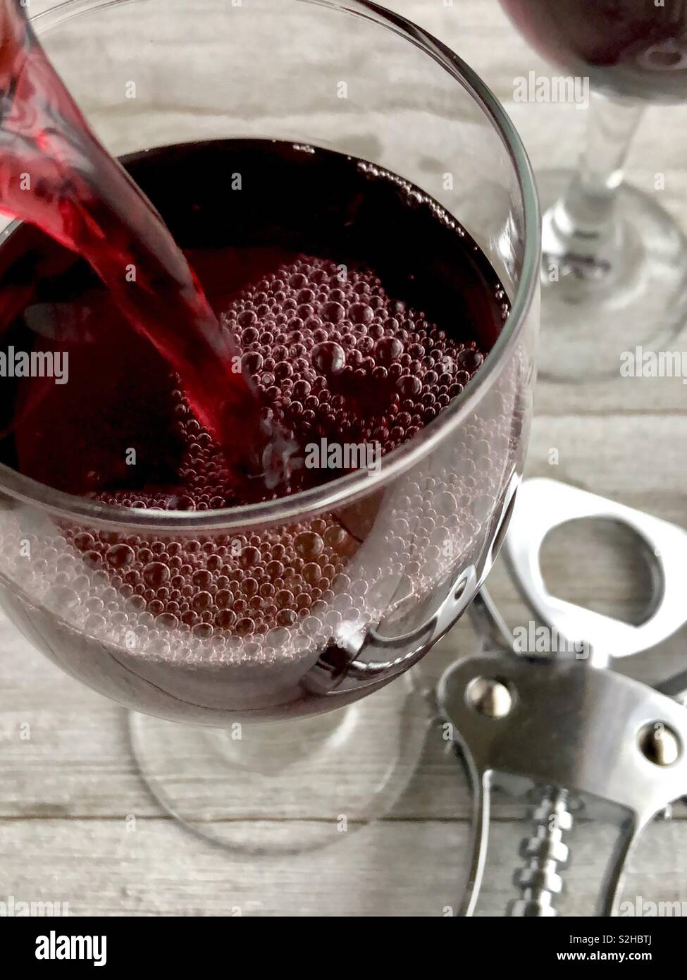 Red wine being poured into a glass - Smartphone Captured Stock Image