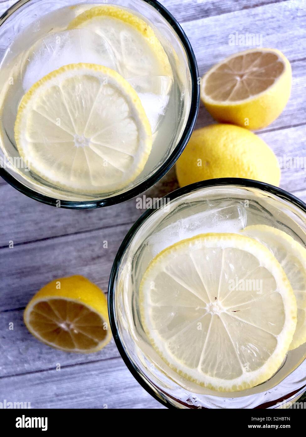 Top view of two ice cold glasses of lemonade on a wooden table - Smartphone Captured Stock Image