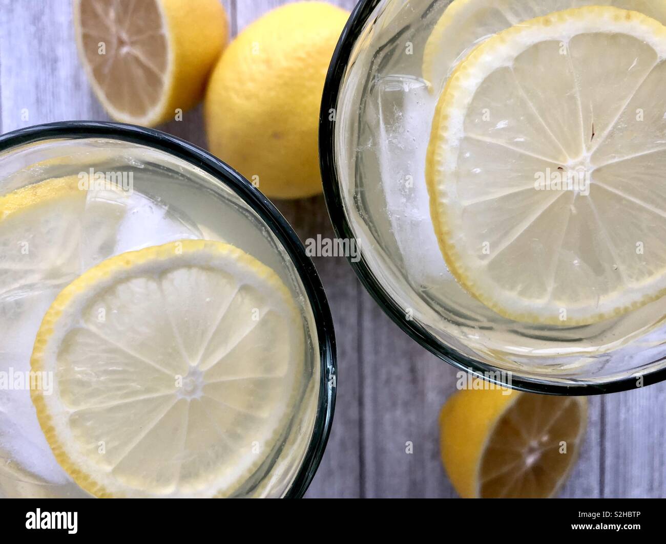 Top view of two ice cold glasses of lemonade on a wooden table - Smartphone Captured Stock Image