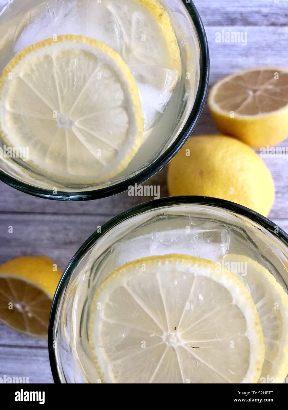 Top view of two ice cold glasses of lemonade on a wooden table Stock Photo