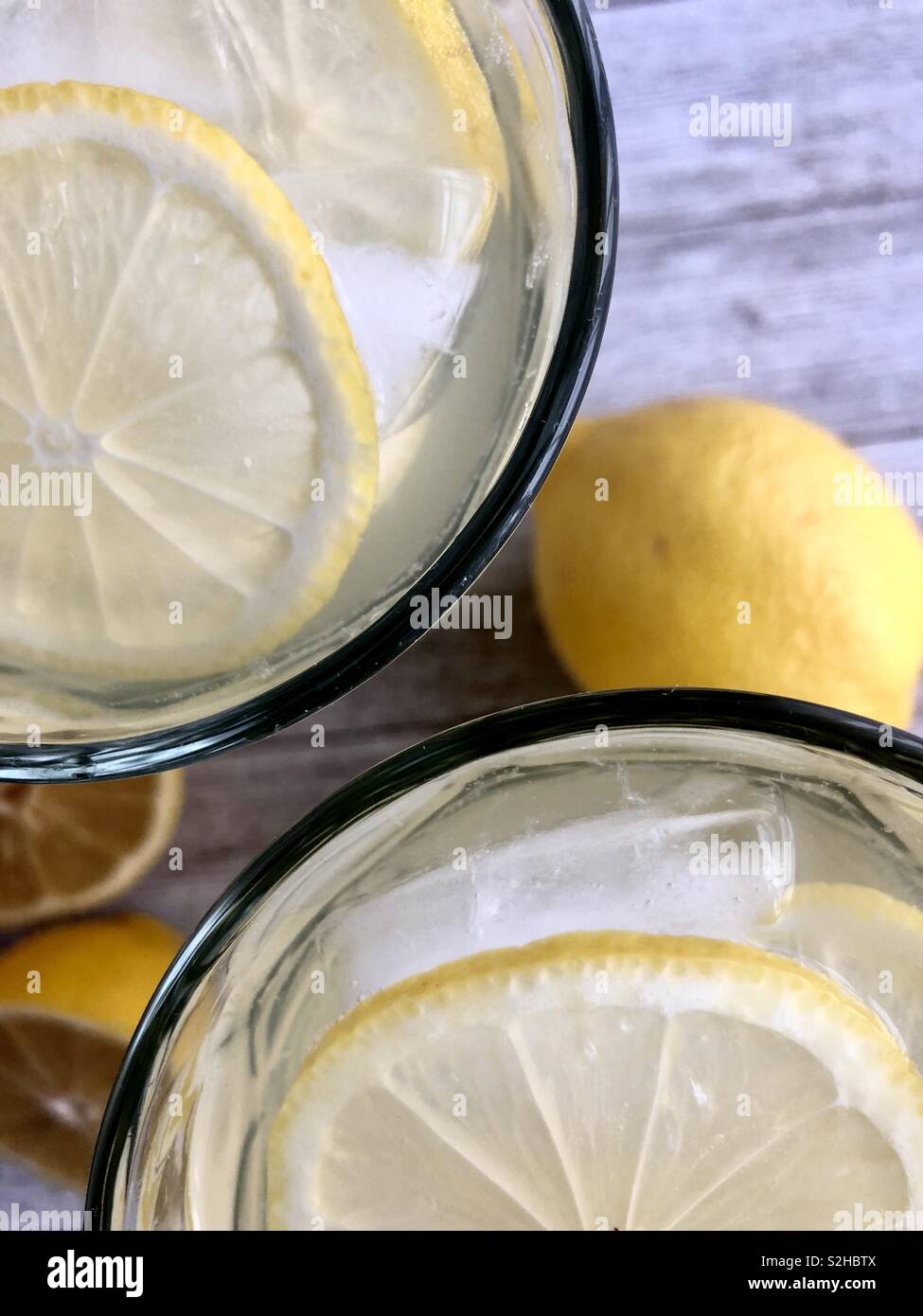 Top view of two ice cold glasses of lemonade on a wooden table - Smartphone Captured Stock Image