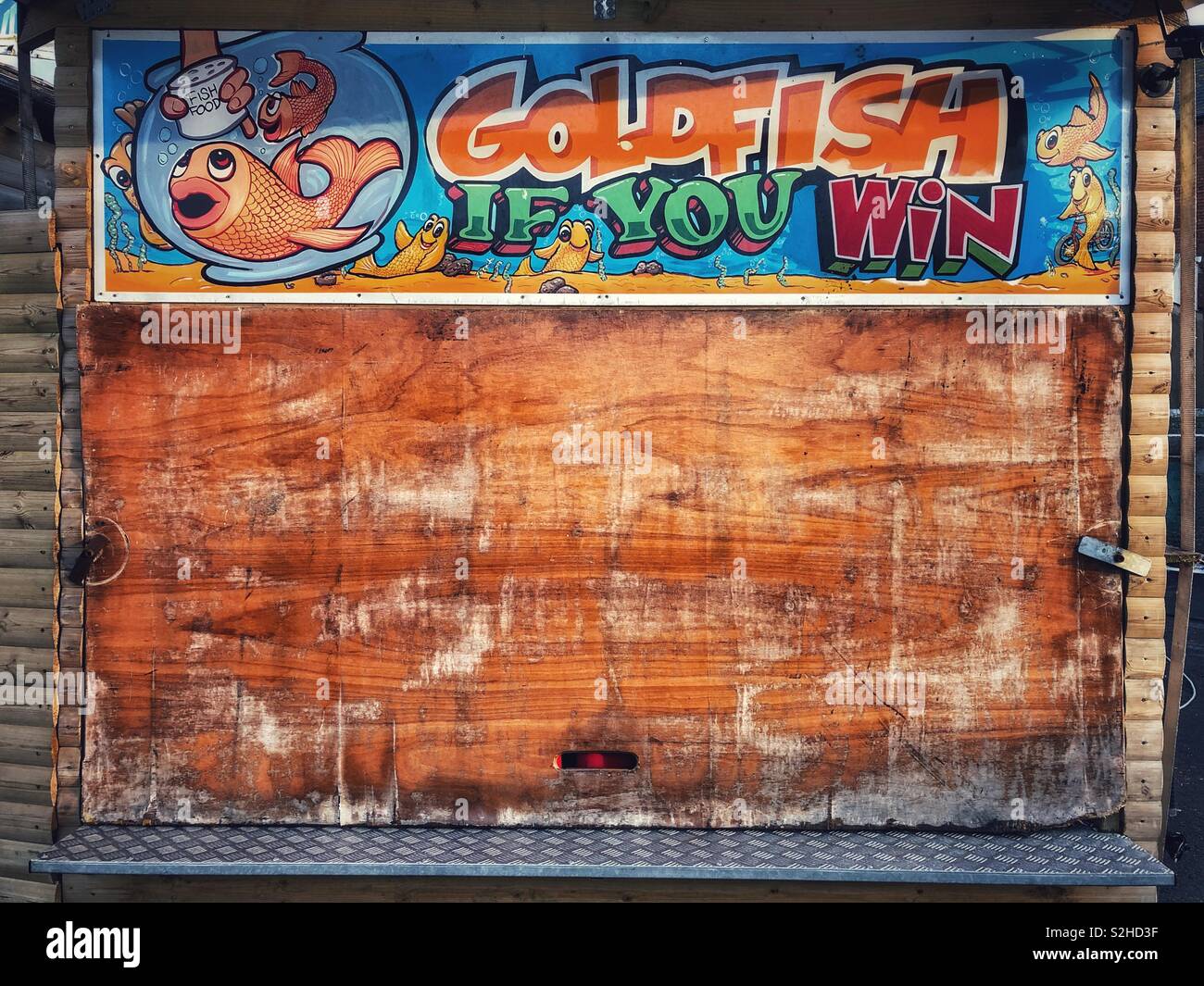 Boarded up fairground stall with goldfish as prizes - Smartphone Captured Stock Image