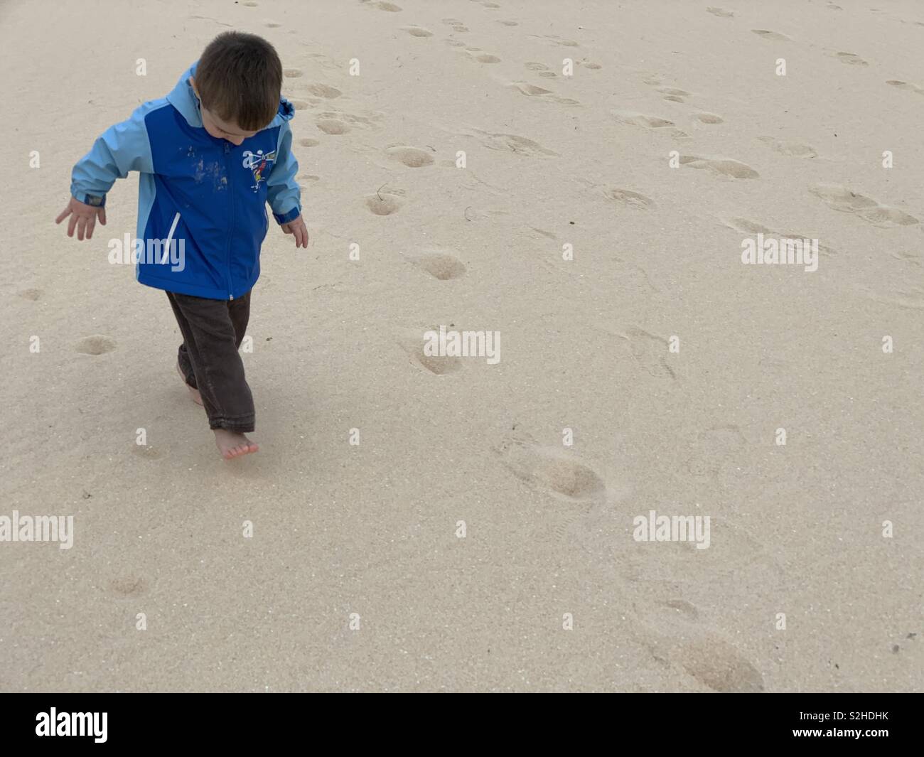 Toddler walking on the sand Corralejo Fuerteventura Canary island Stock Photo