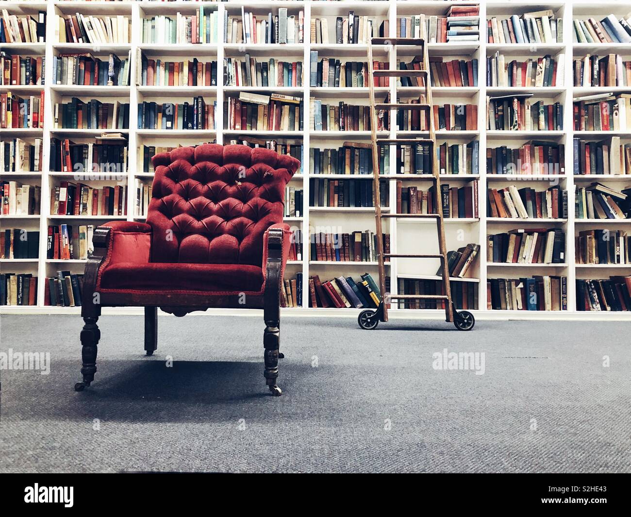 Shelves with antique books in library Stock Photo by ©feanaro