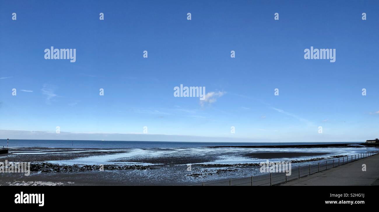 Panorama of Minnie’s Bay Birchington Kent UK with clear blue sky and no