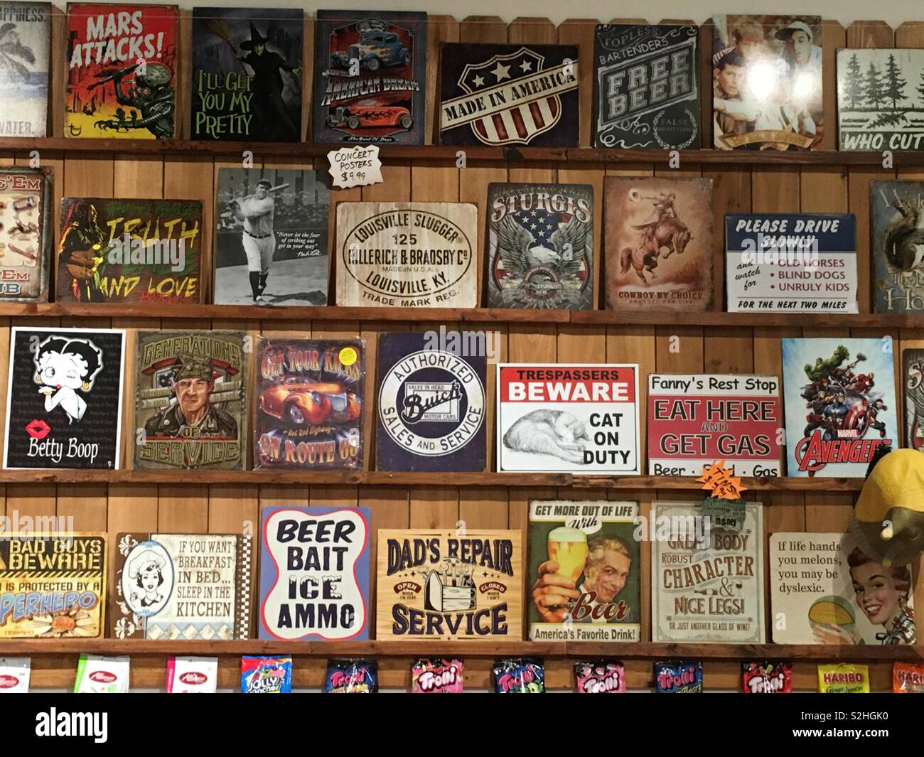 Display wall of classic vintage authentic tin foil advertisements with ad slogans. Stock Photo