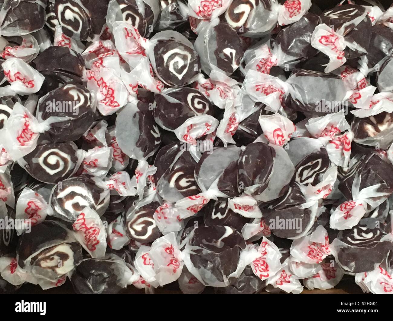 Bulk locally made taffy candy piled high in a basket. Stock Photo