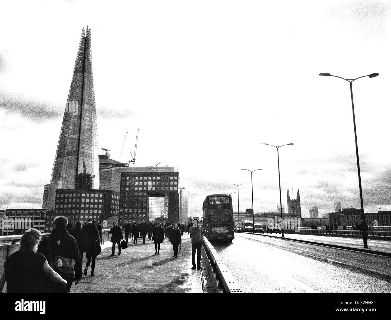 View looking across London Bridge towards Southwark cathedral and the Shard building in England, U.K. Stock Photo
