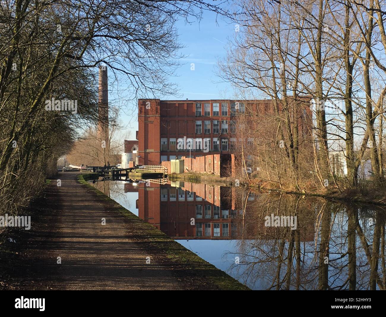 An old mill next to the Canal in Failsworth, Manchester, on a sunny day. (February 2019) Stock Photo