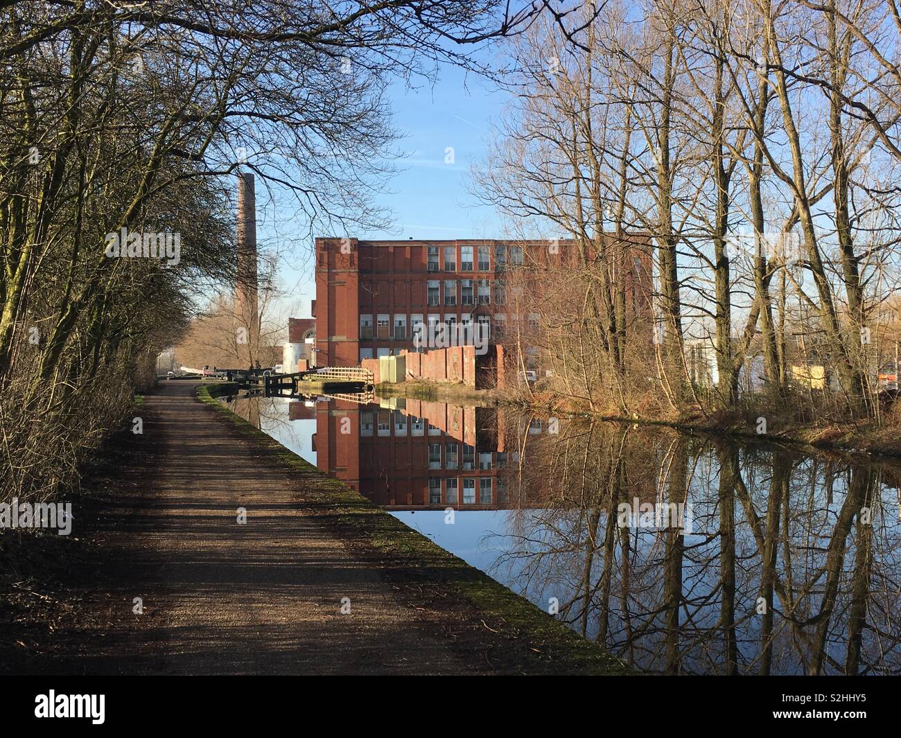 An old mill and chimney, next to the Rochdale Canal, in Failsworth, Manchester. February 2019. Stock Photo
