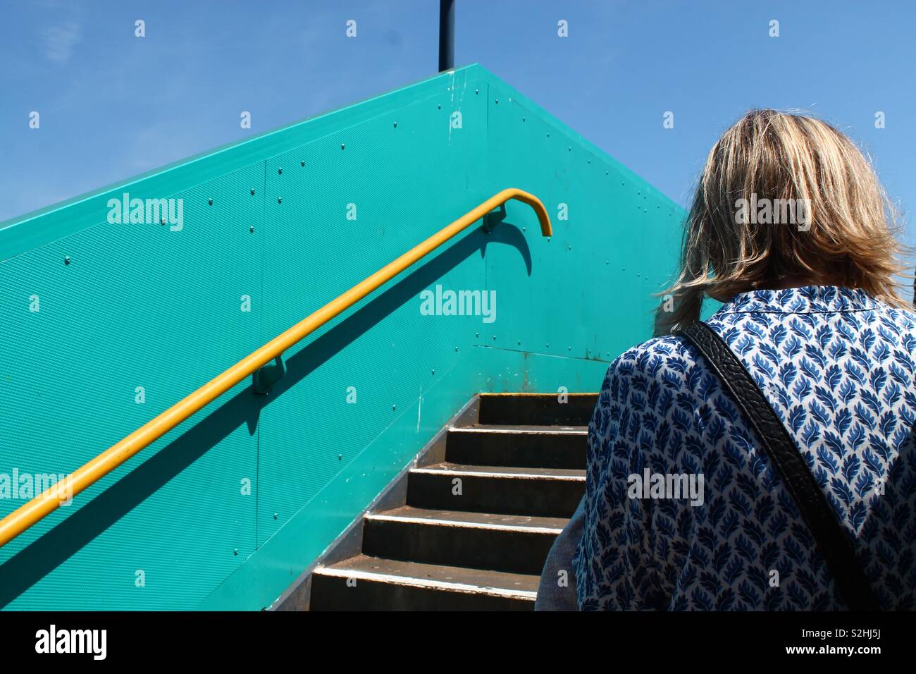 Woman standing in front of a stairwell Stock Photo