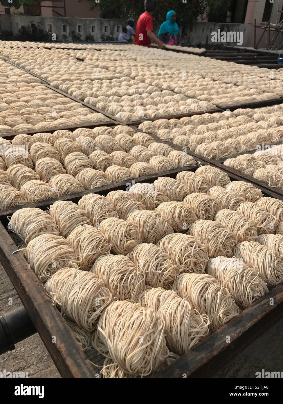 Drying noodles in open air at a local Chinese factory, Zanzibar - Smartphone Captured Stock Image