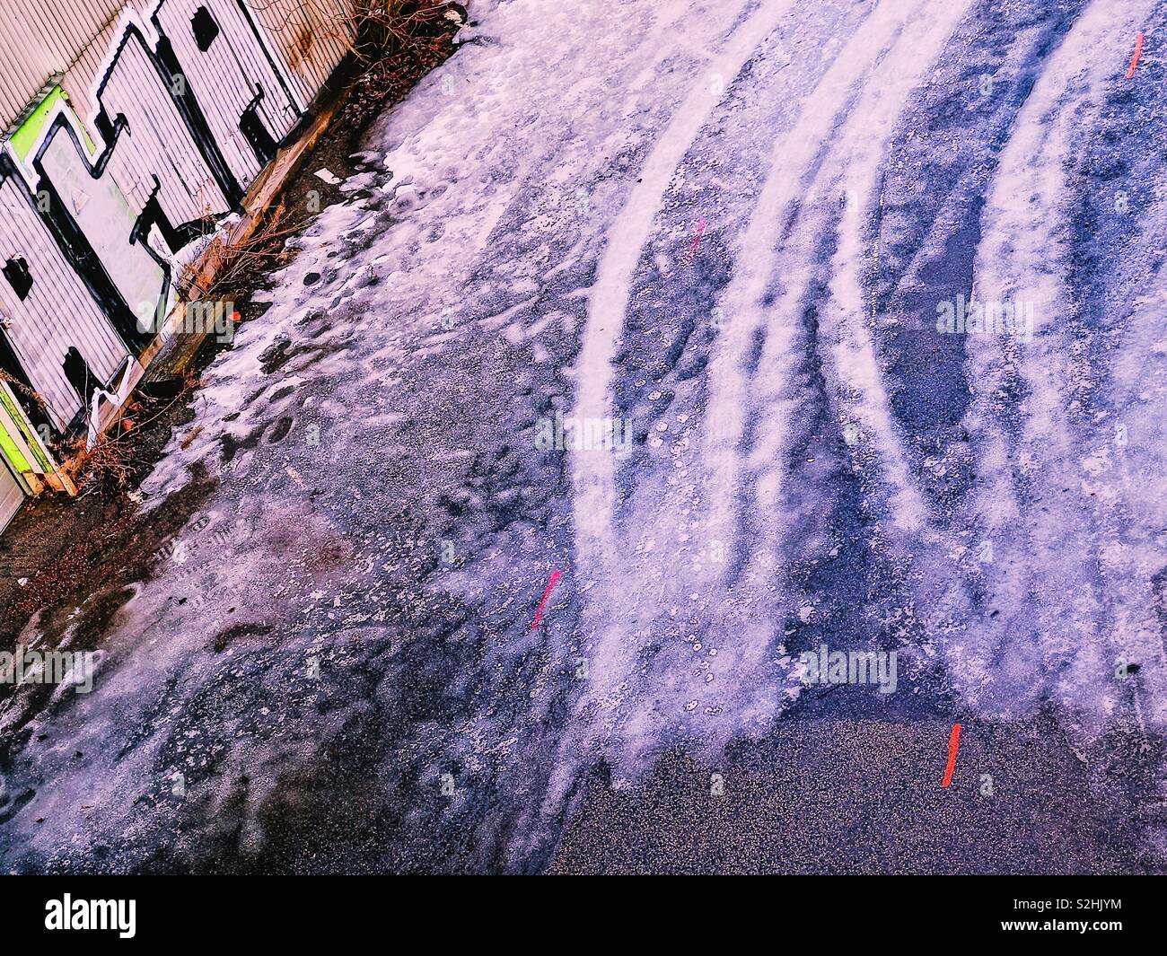 Tyre tracks frozen in ice and graffiti - Smartphone Captured Stock Image