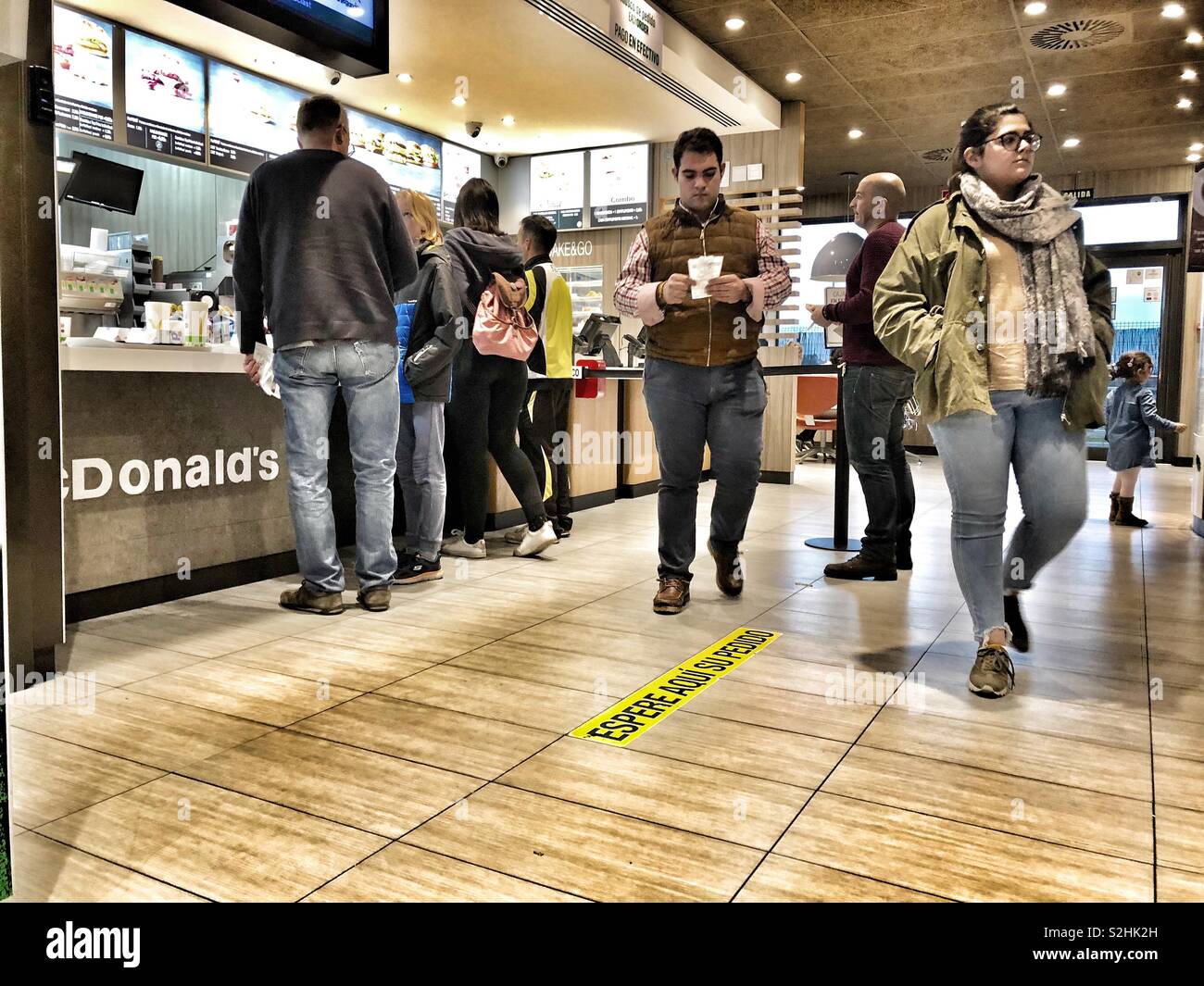 Customers in McDonald’s in Seville, Spain - Smartphone Captured Stock Image