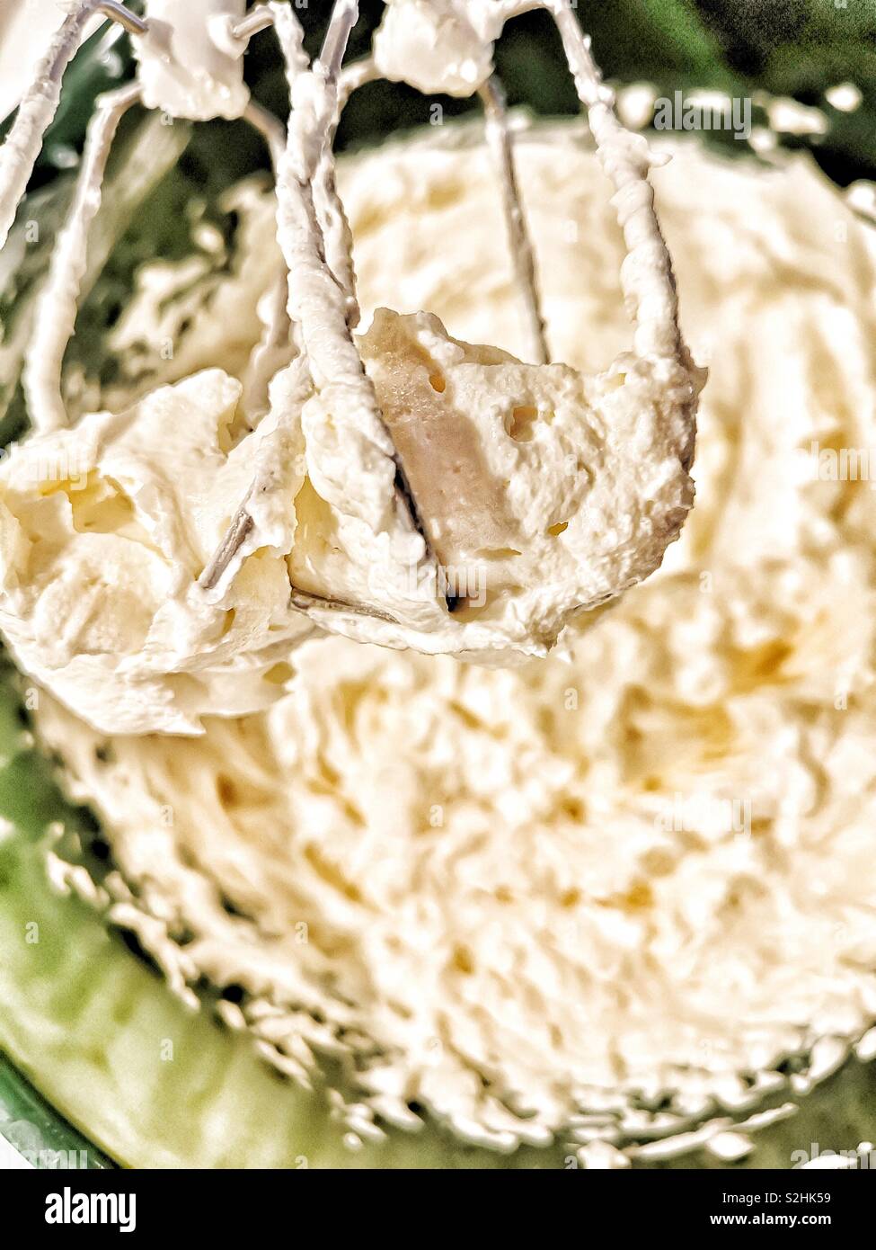 Whisking cream cheese, eggs, caster sugar, vanilla and sour cream to make cheesecake - Smartphone Captured Stock Image