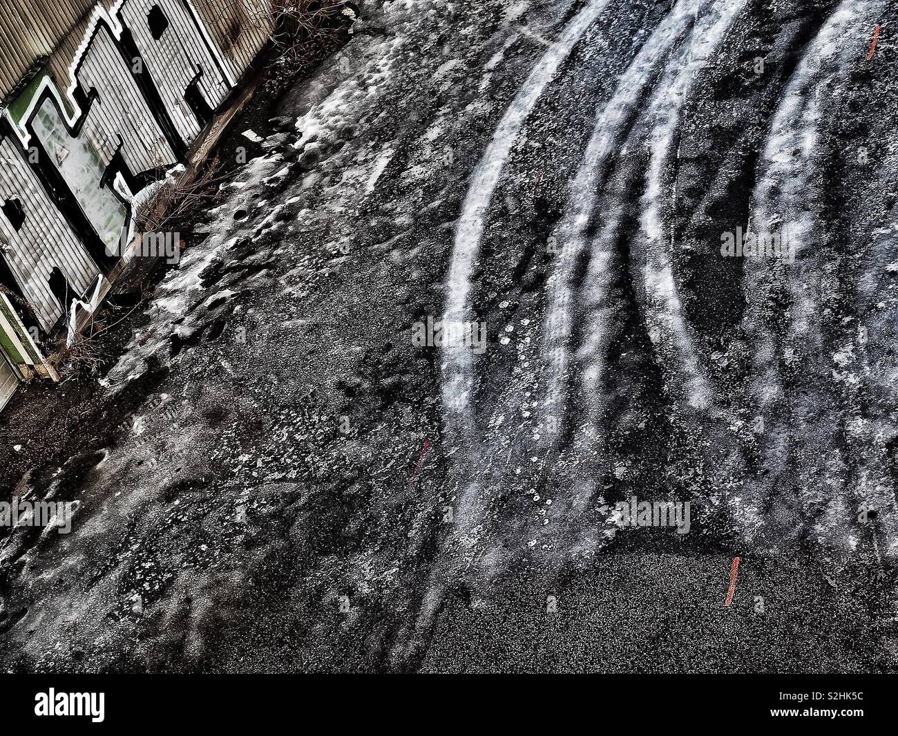 Tyre tracks frozen in ice and graffiti - Smartphone Captured Stock Image