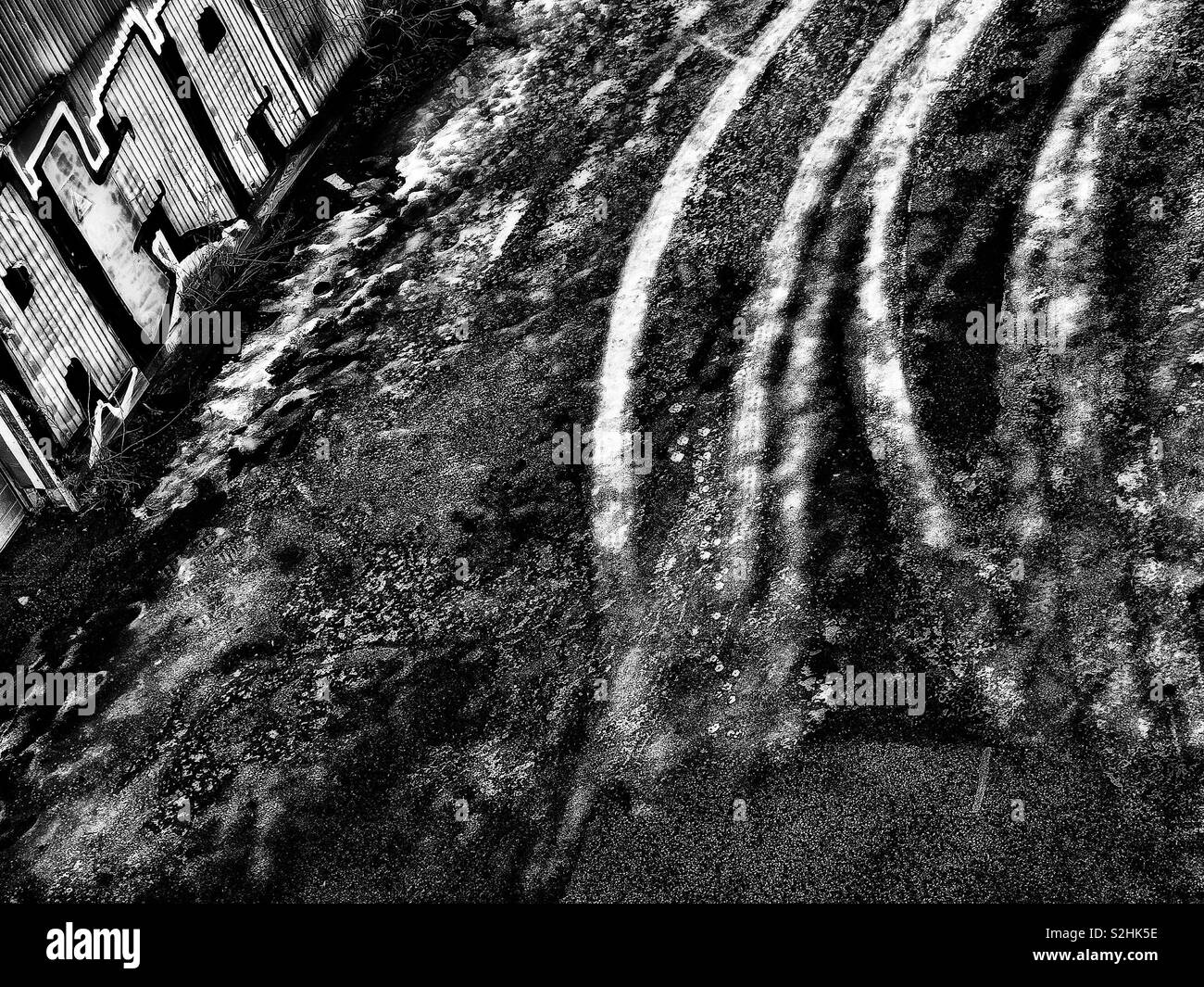 Tyre tracks frozen in ice and graffiti - Smartphone Captured Stock Image