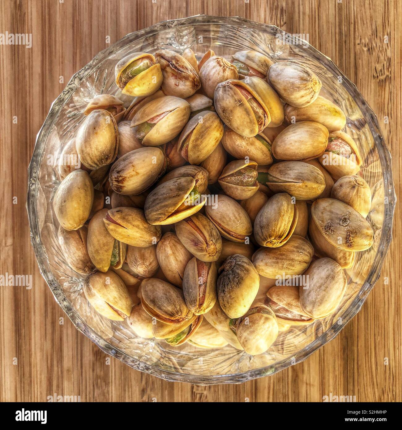 Pistachio nuts in a crystal bowl Stock Photo