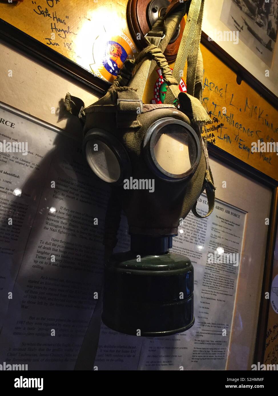 A gas mask hangs from a hook on the wall, ready for use - Smartphone Captured Stock Image