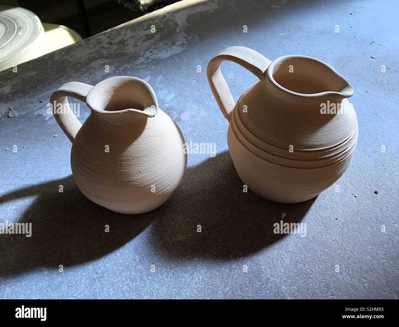 https://c8.alamy.com/comp/S2HMX3/two-small-pottery-olive-oil-jugs-waiting-to-be-glazed-S2HMX3.jpg