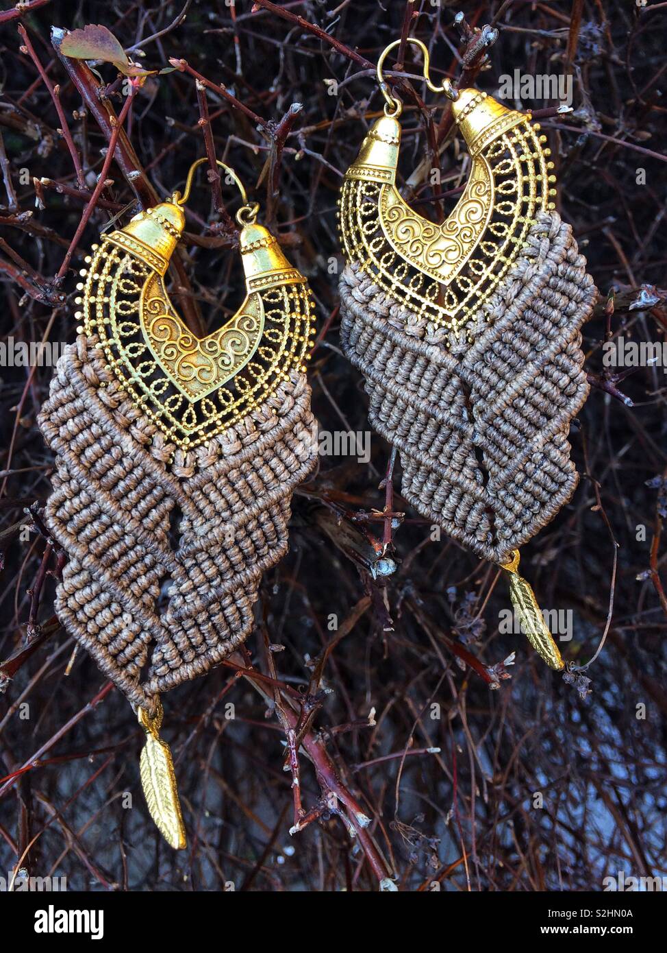 Boho macrame brass earrings Stock Photo - Alamy