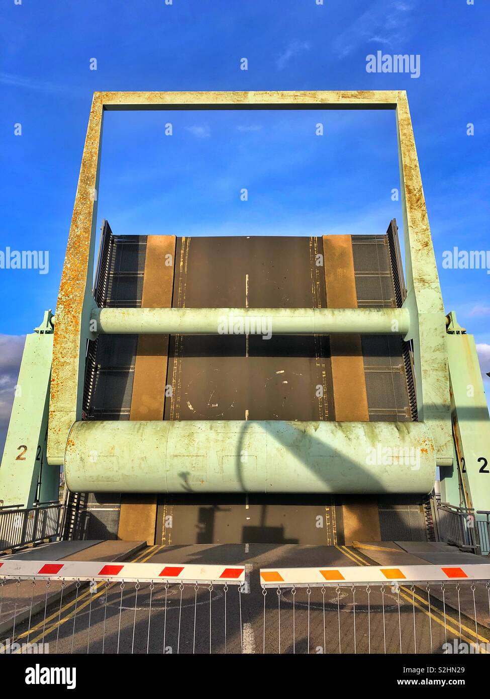 Road lifted to allow tall masted boats to enter Cardiff Bay through the lock gates. - Smartphone Captured Stock Image