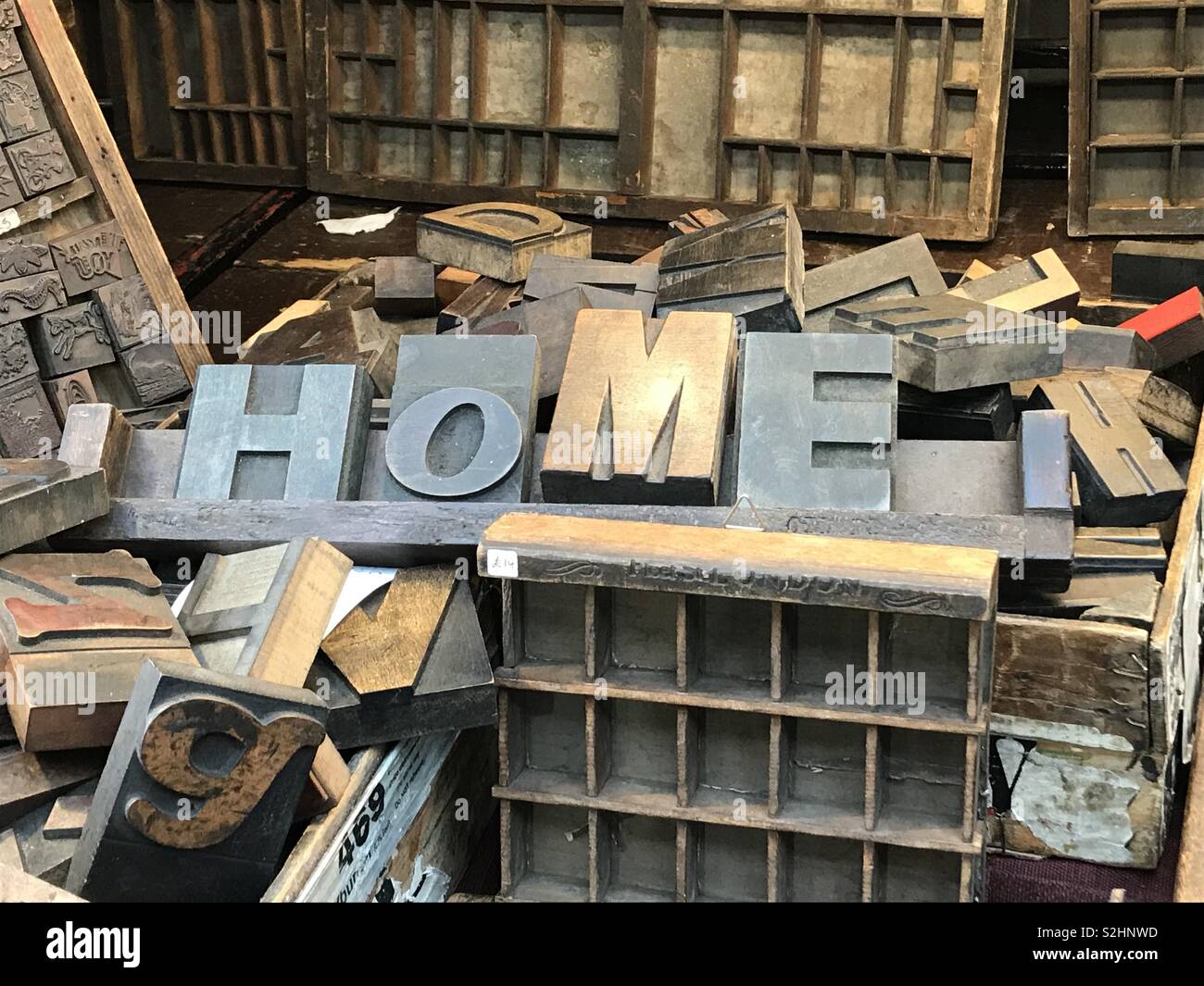 Wooden printing blocks, making a “home” sign. Stock Photo