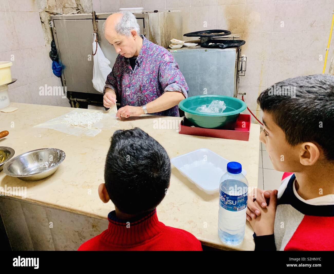 Preparing traditional pastry sweet in Zalatimo sweet shop in the old city of Jerusalem. - Smartphone Captured Stock Image