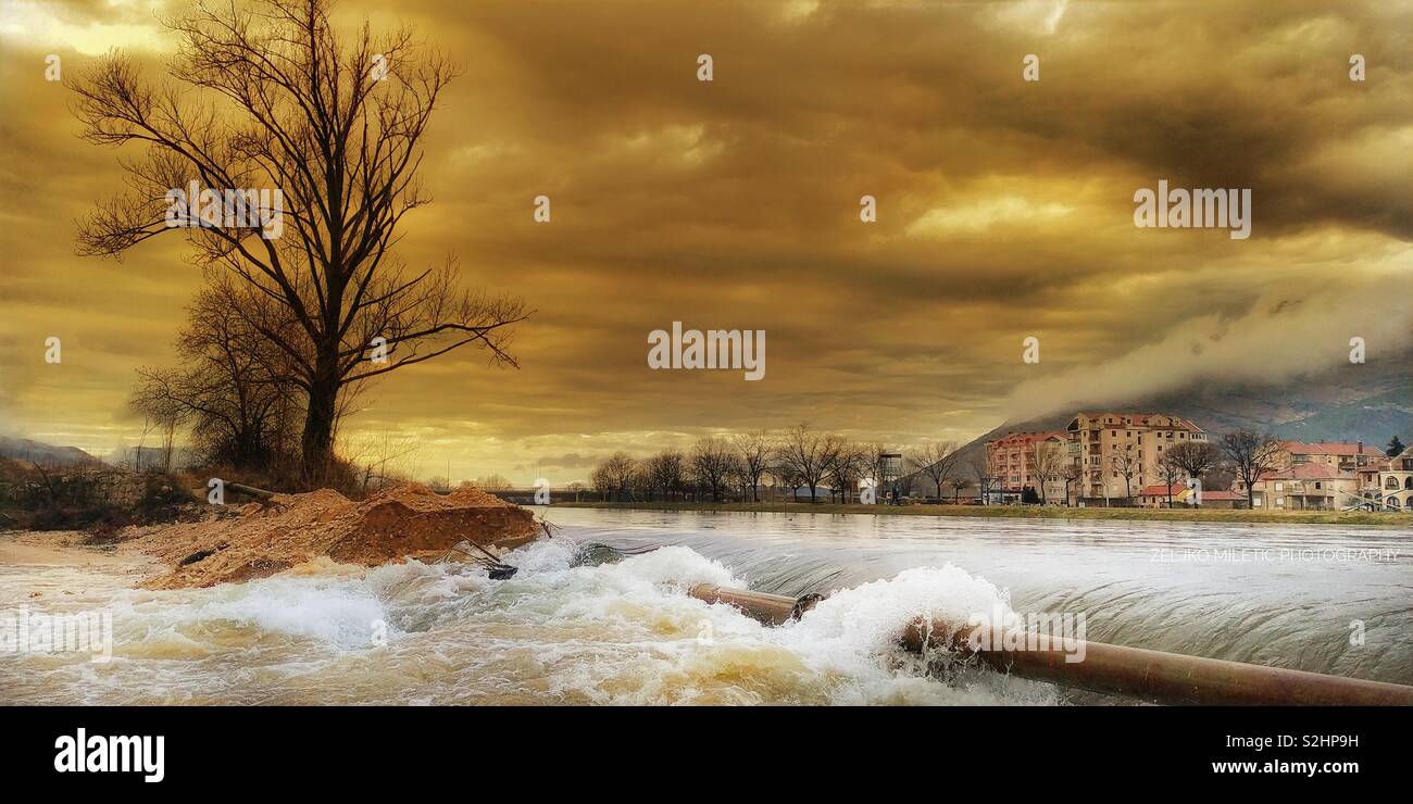 Angry river and moody skies Stock Photo