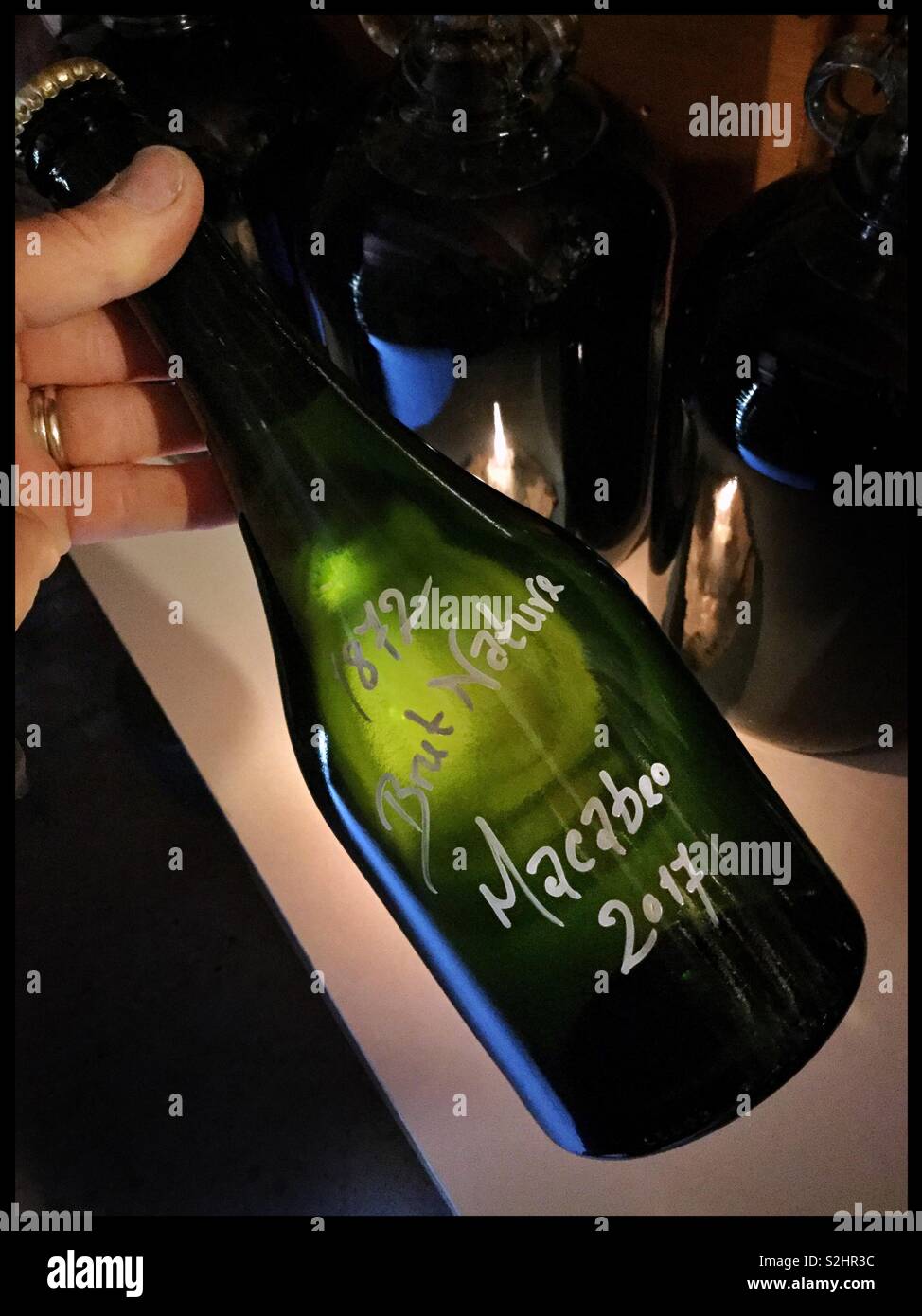 A bottle of homemade sparkling wine from Macabeo grapes, Catalonia, Spain. - Smartphone Captured Stock Image