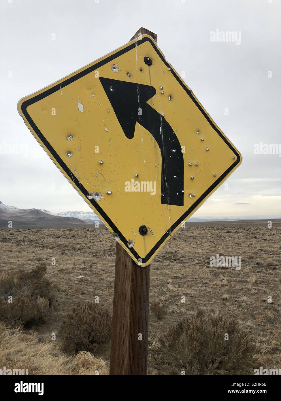 A sign riddled with bullet holes Stock Photo - Alamy