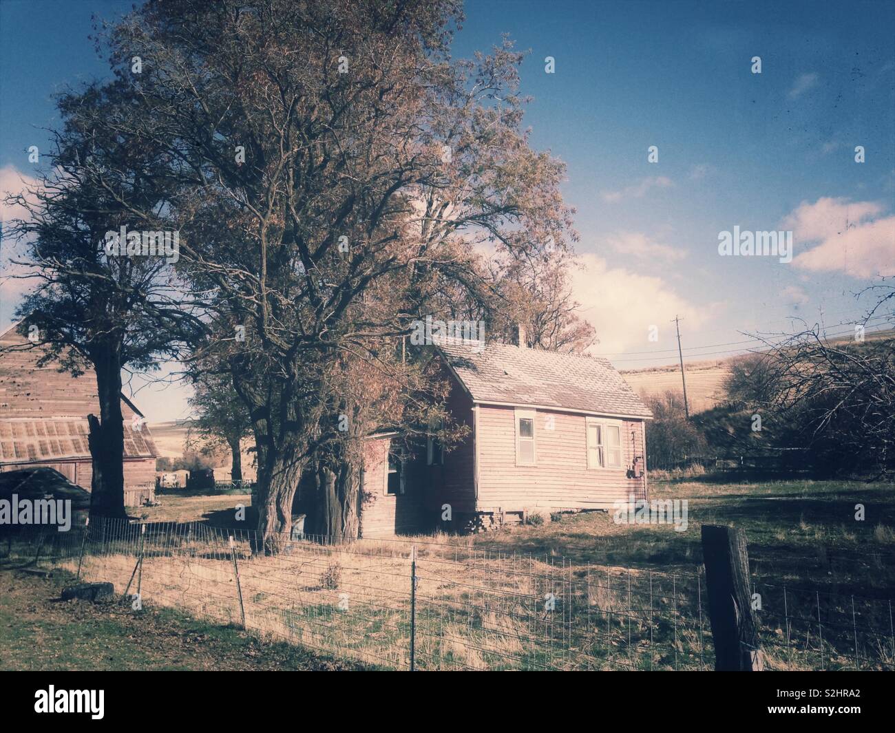 Vintage style photo of house and barn against rolling Eastern Washington hillside in November - Smartphone Captured Stock Image