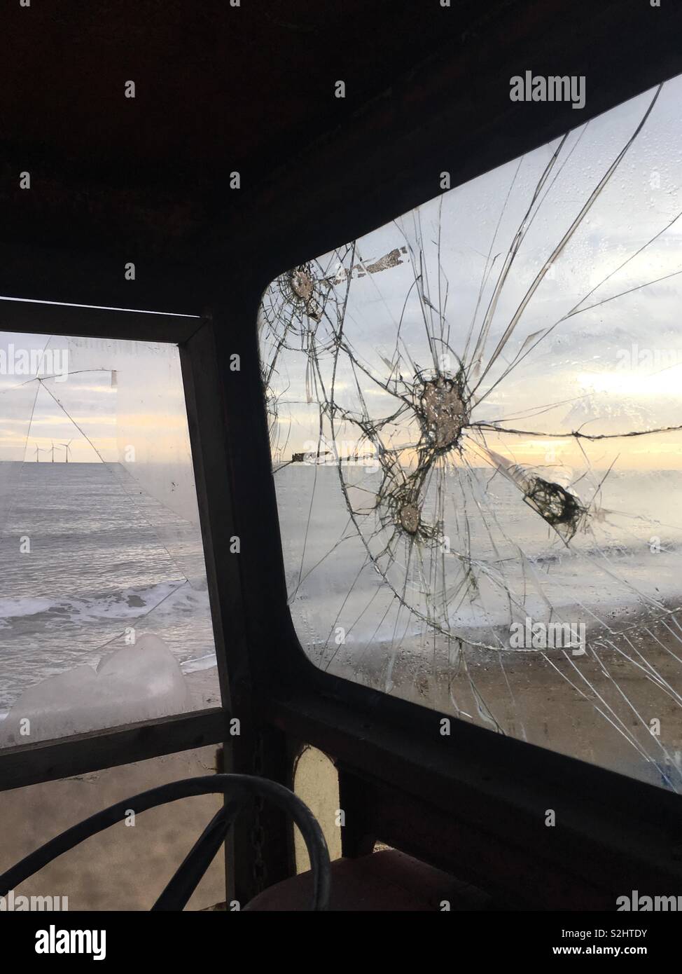 Beach viewed through a broken window of a vehicle. Caister-on-Sea, Norfolk, UK. - Smartphone Captured Stock Image