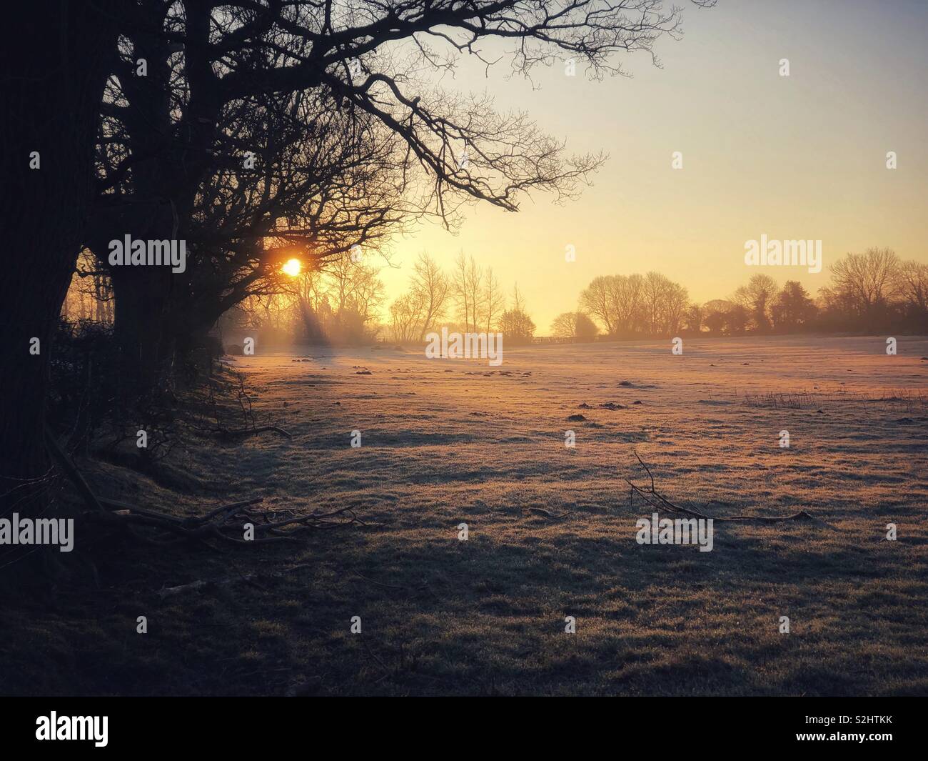 Morning sunrise on a winters day, as a fresh covering of snow covers the land. - Smartphone Captured Stock Image