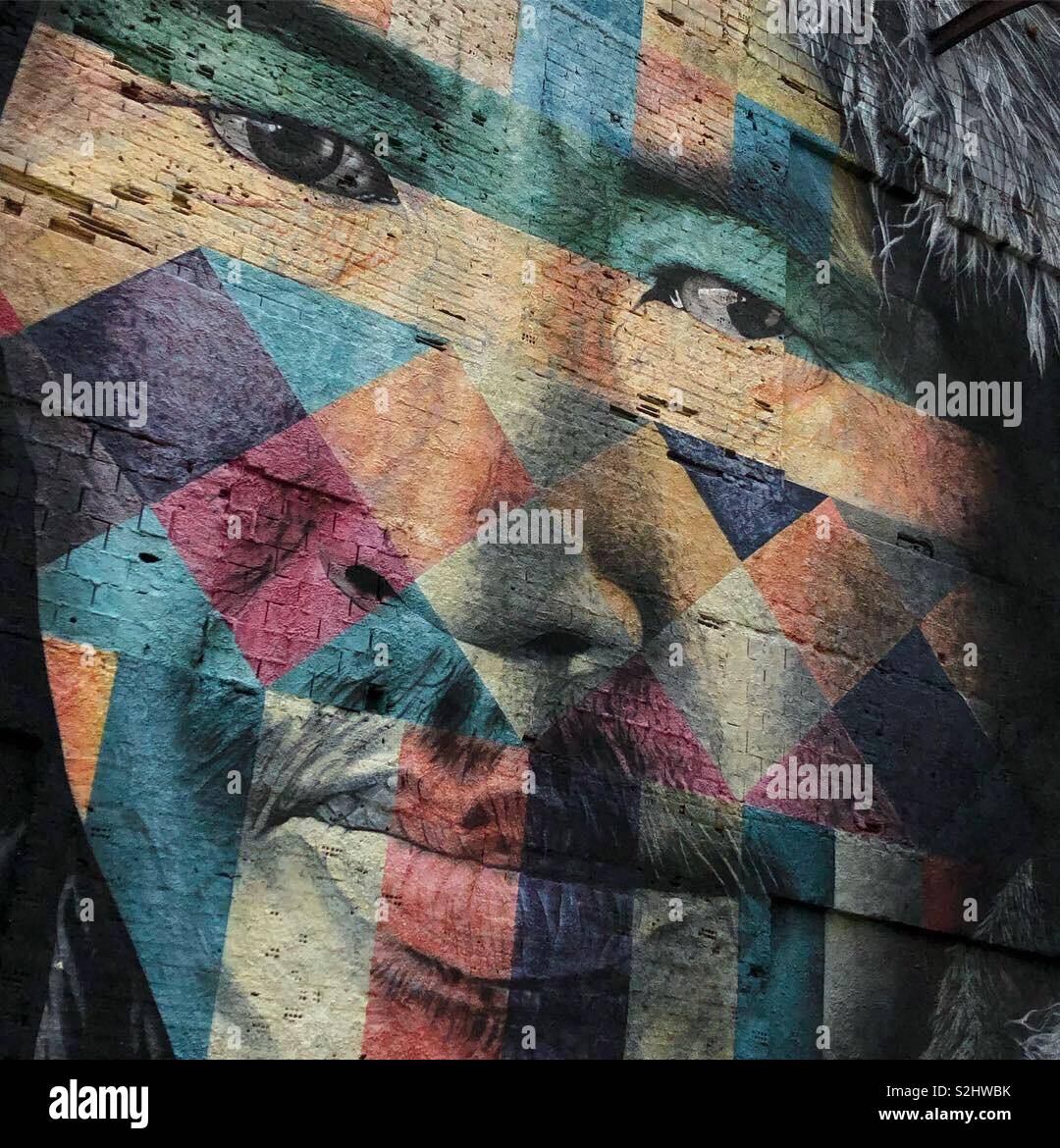 Larger-than-life street art of a multicoloured Indigenous face in Rio de Janeiro, Brazil, painted by Brazilian Eduardo Kobra. It is part of a series called Etnias. - Smartphone Captured Stock Image