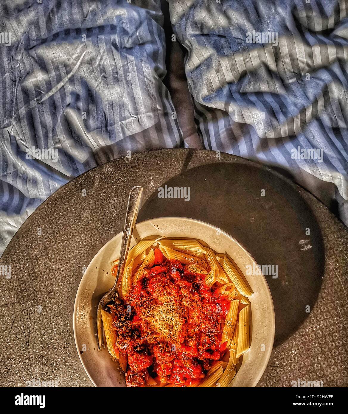 Top view of pasta dinner in bed on tray - Smartphone Captured Stock Image