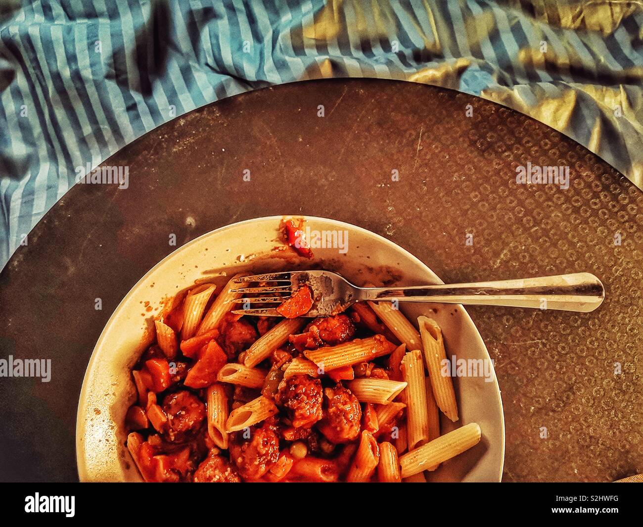 Top view of pasta dinner in bed on tray - Smartphone Captured Stock Image