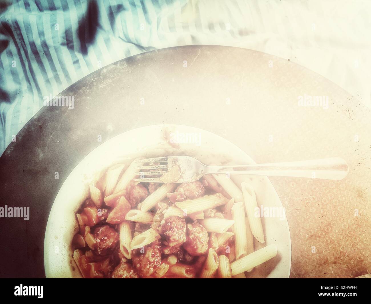 Top view of pasta dinner in bed on tray - Smartphone Captured Stock Image