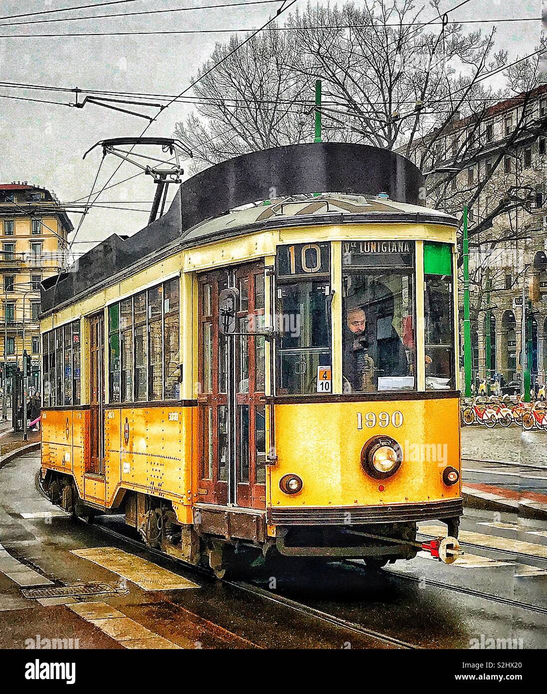 A classic tram on its way through the streets of Milan, Italy Stock Photo