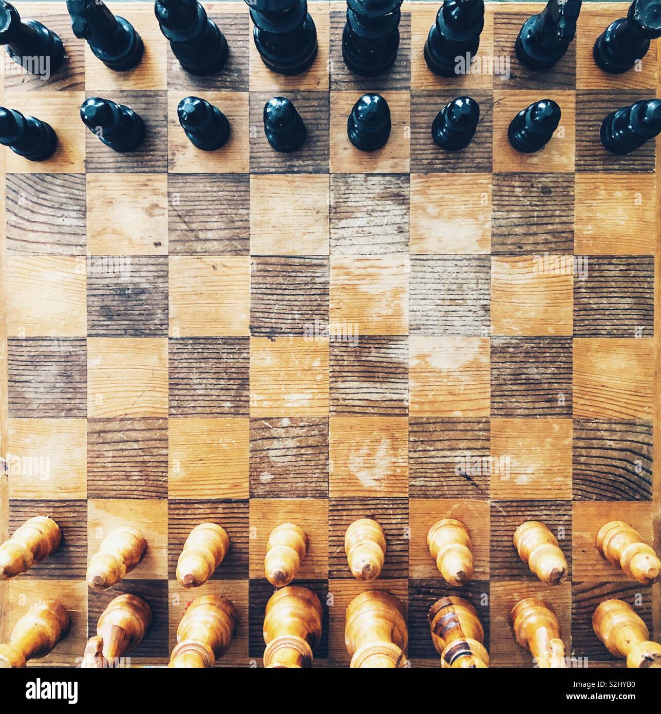 Directly above old, rustic wooden chess board game - Smartphone Captured Stock Image