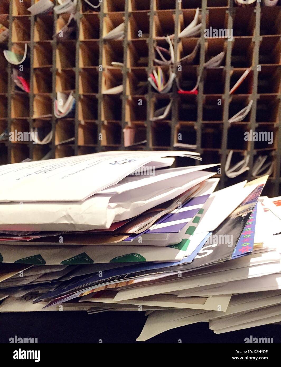 Large stack of delivered mail in front of hotel letter boxes, USA - Smartphone Captured Stock Image
