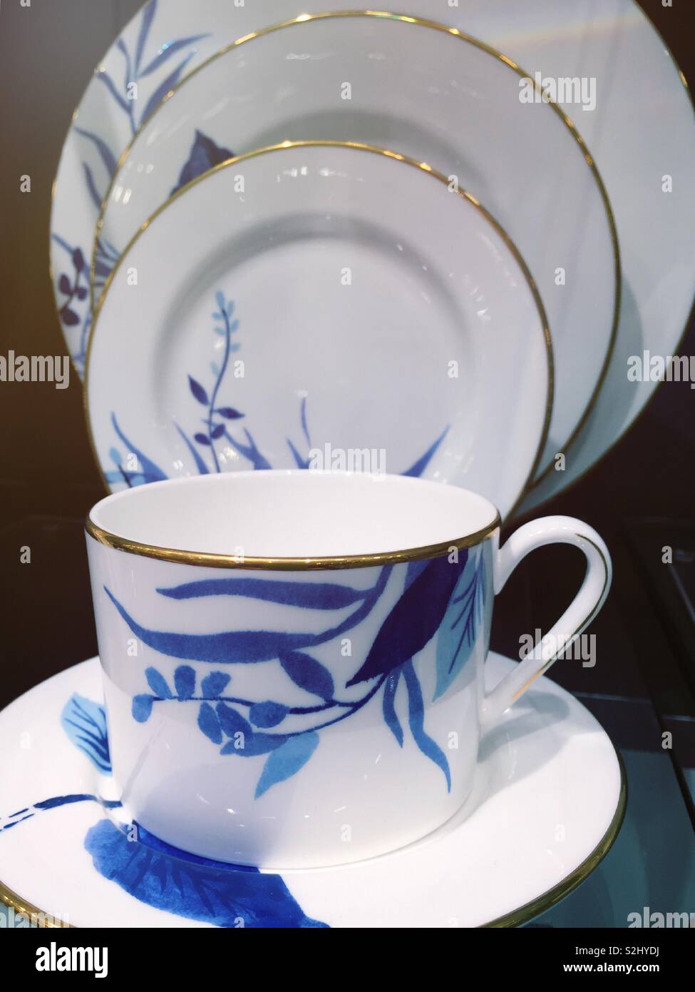 White and blue china cup and saucer display on sale in an upscale
