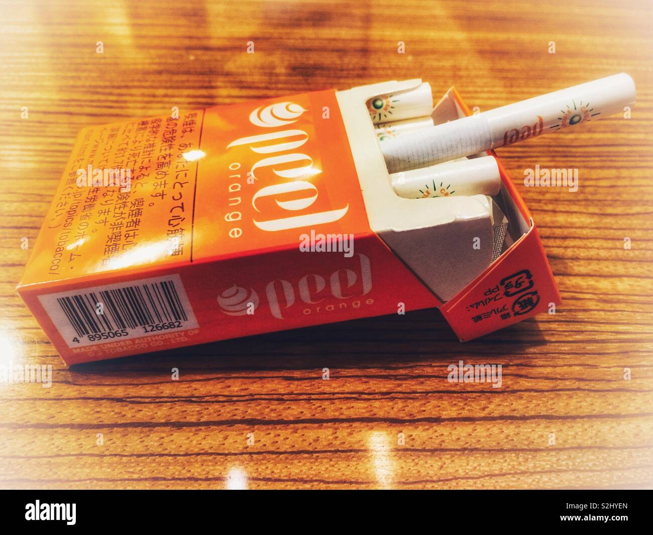 A pack of Japanese Peel Orange cigarettes on a table Stock Photo