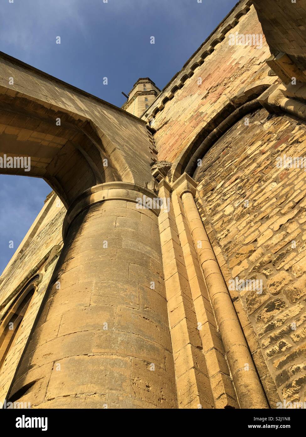 Unusual view point looking up buttresses and tower of Pershore Abbey. - Smartphone Captured Stock Image