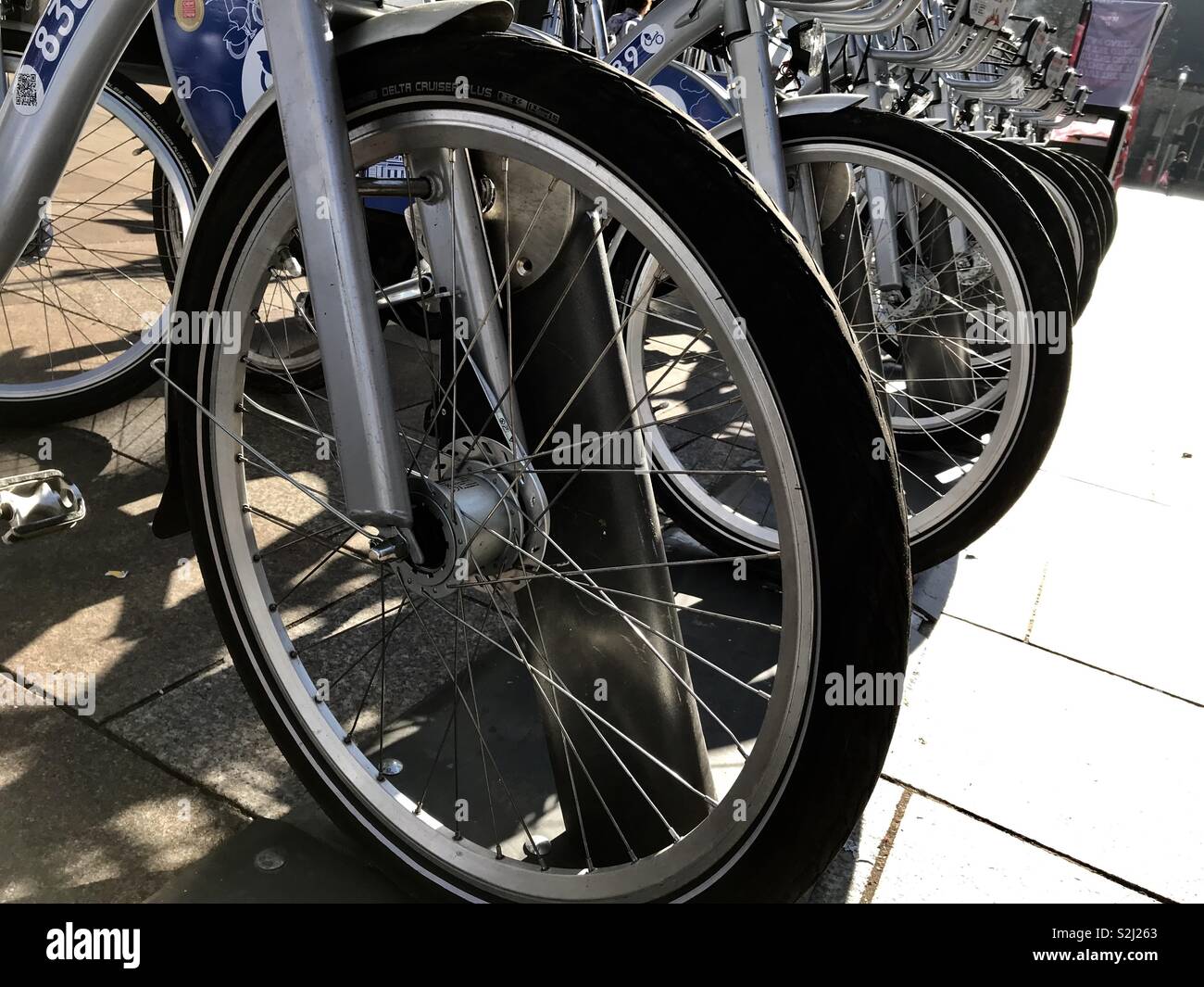 Bike/cycle rack with Next Bikes for hire in a city. Stock Photo