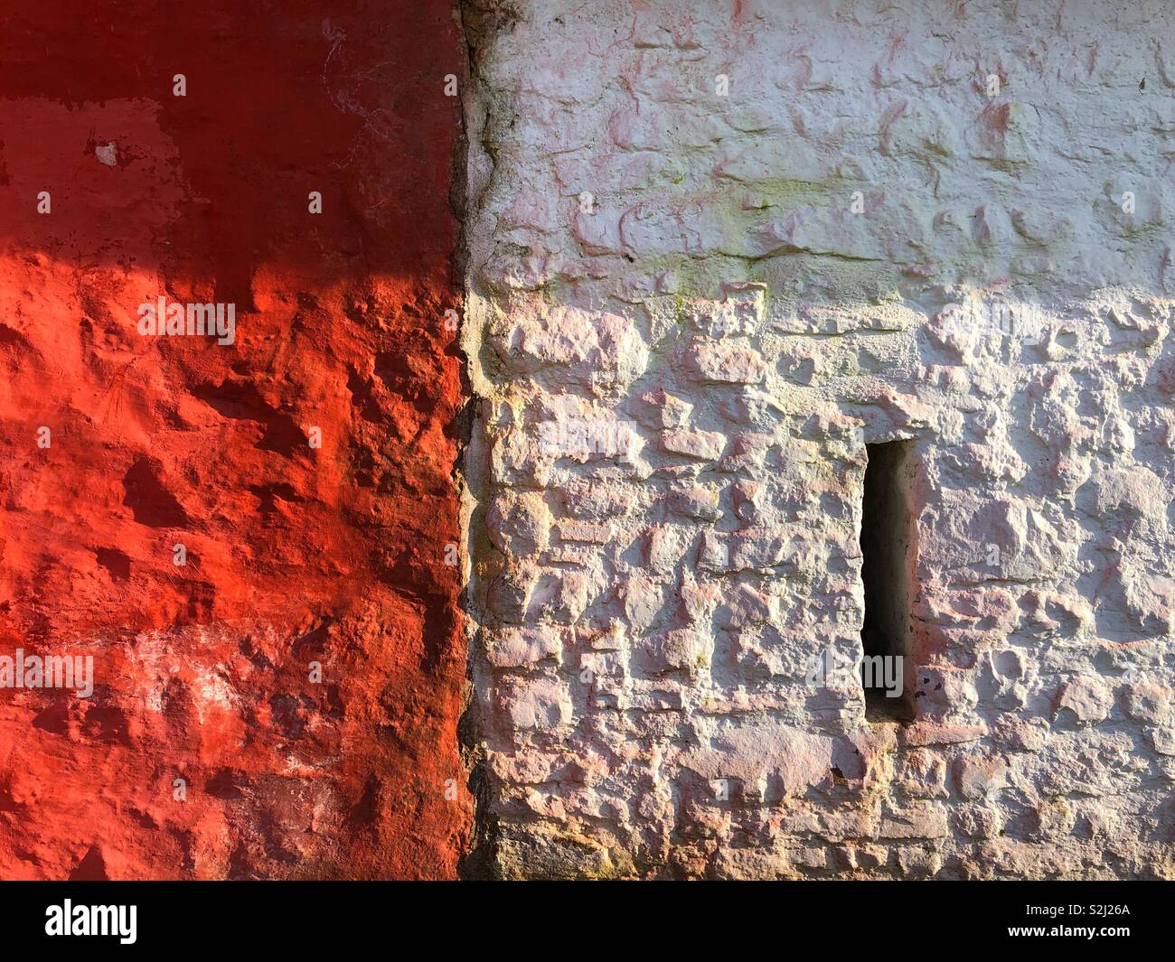 Detail of two old fashioned thatched cottages at St Fagans Museum of Welsh Life, one of which has a window slit. - Smartphone Captured Stock Image